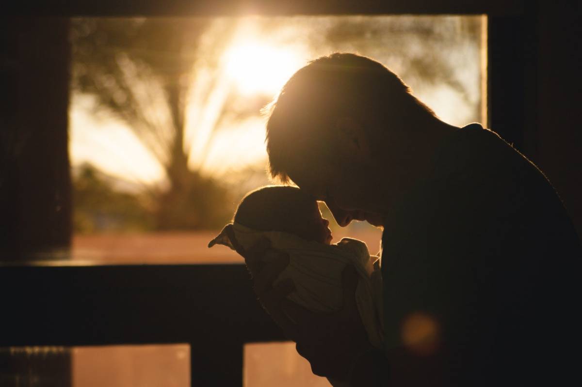 a man holding a baby