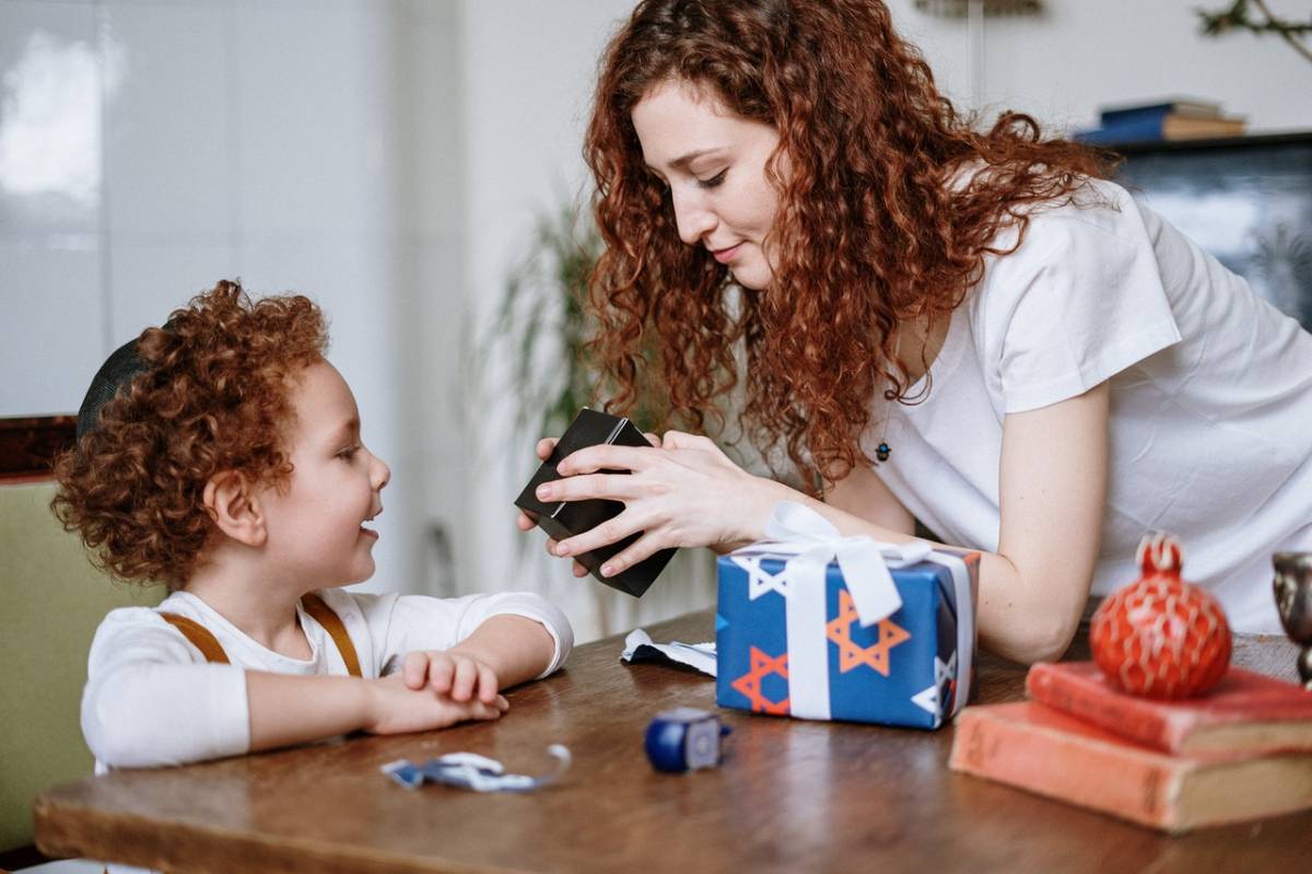 a mother and a kid opening presents